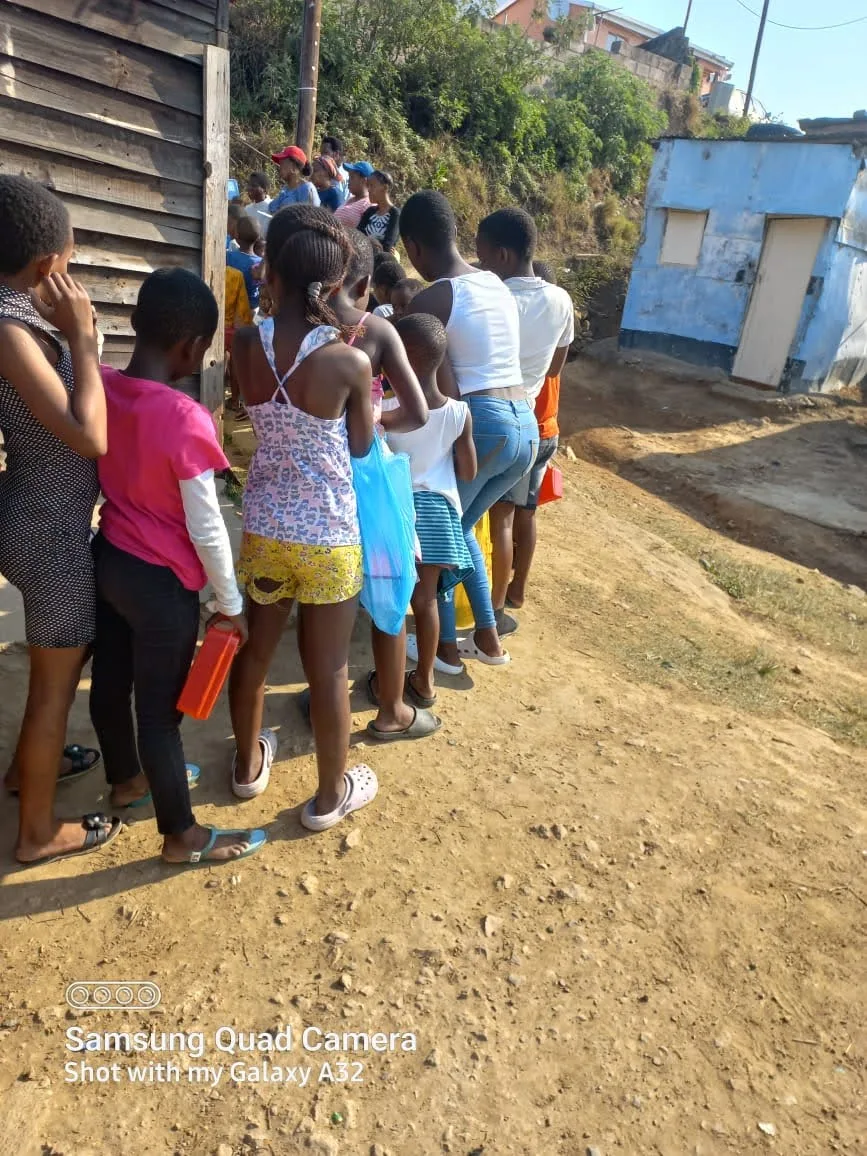 Children receiving meals under the OTEGA Foundation feeding programme